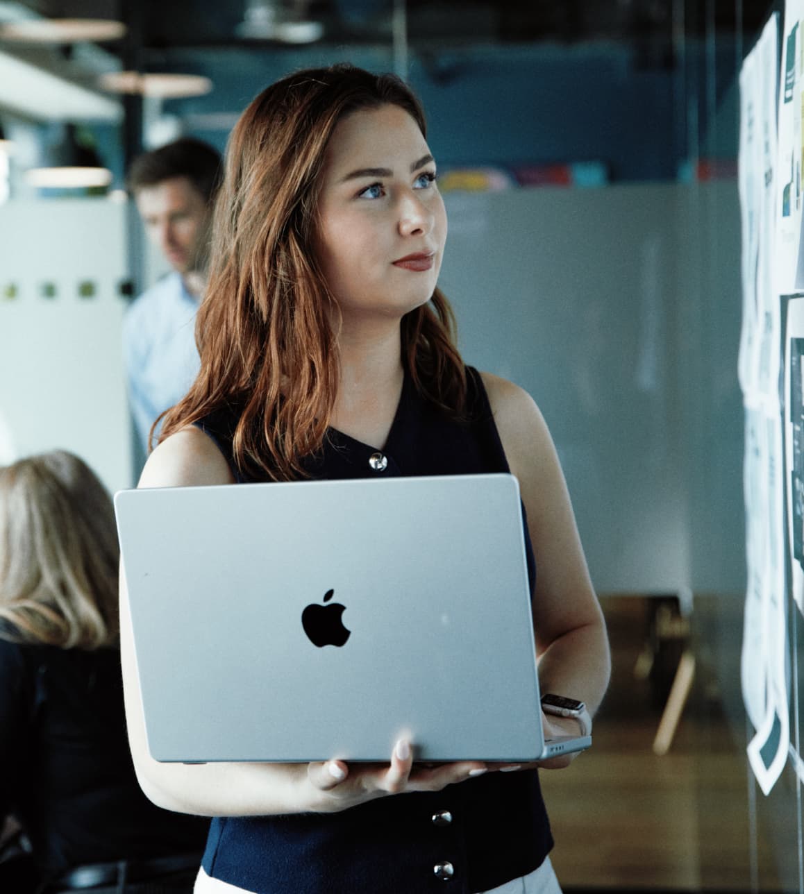 A designer studies various concept drafts, evaluating layout and visual direction.